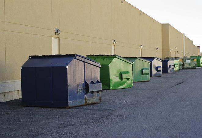 a row of large construction dumpsters on-site in Austin, AR